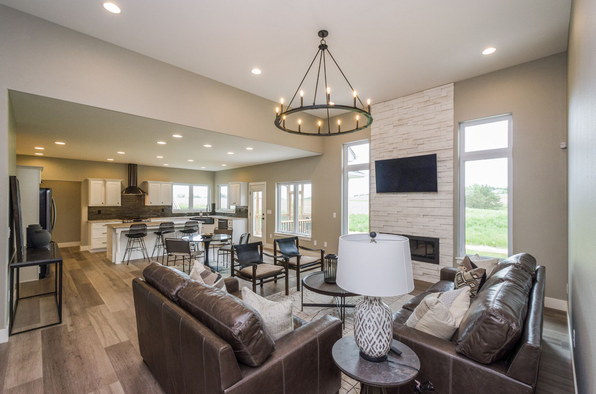 Great room with stone fireplace and country views